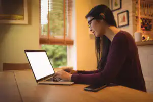 woman using laptop table living room woman using laptop table living room
